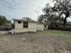 Property features a large backyard with mature trees at 4935 Mockingbird Dr, Dade City, FL 33523