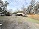 Spacious backyard with a shed, trees, and partially visible inground pool at 4935 Mockingbird Dr, Dade City, FL 33523