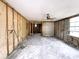 Under renovation, gutted living room with exposed framing and tile floor at 4935 Mockingbird Dr, Dade City, FL 33523