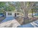 Charming bungalow home with a large tree and a paved driveway at 634 Newton S Ave, St Petersburg, FL 33701