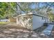 Light beige block home exterior with a walkway and mature trees at 634 Newton S Ave, St Petersburg, FL 33701