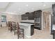 Modern kitchen with a granite island, stainless steel oven, and dark cabinets at 33161 Kateland Dr, Wesley Chapel, FL 33545