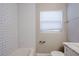 Clean bathroom with white subway tile, marble vanity, and window at 4675 20Th S Ave, St Petersburg, FL 33711