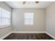 Bright bedroom with dark brown wood-look flooring and two windows at 4675 20Th S Ave, St Petersburg, FL 33711