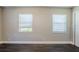 Bright bedroom with dark brown wood-look flooring and two windows at 4675 20Th S Ave, St Petersburg, FL 33711