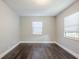 Bright bedroom with dark brown wood-look flooring and two windows at 4675 20Th S Ave, St Petersburg, FL 33711