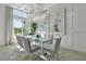 Elegant dining room with a large glass table and crystal chandelier at 8500 Candlewood Ct, Sarasota, FL 34240