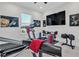 Modern home gym featuring treadmill and weight bench at 8500 Candlewood Ct, Sarasota, FL 34240