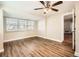 Living room with bay window, wood-look floors, and ceiling fan at 6412 Skyline Ct, Spring Hill, FL 34606