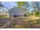 Back of house with a large yard and trees at 6009 N 39Th St, Tampa, FL 33610