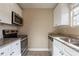 Modern kitchen with stainless steel appliances and granite counters at 6009 N 39Th St, Tampa, FL 33610