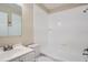 Bathroom with white bathtub, vanity, and tiled walls at 5405 Mariner Blvd, Spring Hill, FL 34609