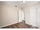 Bedroom with wood-look vinyl flooring and access to another bedroom at 5405 Mariner Blvd, Spring Hill, FL 34609