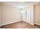 Bedroom with wood-look vinyl flooring and double sliding doors to closet at 5405 Mariner Blvd, Spring Hill, FL 34609