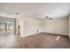 Bright living room with wood-look vinyl flooring and a sliding glass door leading to the backyard at 5405 Mariner Blvd, Spring Hill, FL 34609