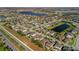 Aerial view of community with lake at 1570 Fox Grape Loop, Lutz, FL 33558