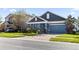 Two-story house with blue siding, gray roof, and a two-car garage at 1570 Fox Grape Loop, Lutz, FL 33558