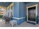 Inviting front porch with wicker chairs and a white ottoman at 1570 Fox Grape Loop, Lutz, FL 33558
