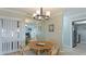 Bright dining room with table for four and view into kitchen at 524 Beach Rd # A, Sarasota, FL 34242