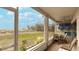 Screened porch overlooking grassy yard and distant ocean at 524 Beach Rd # A, Sarasota, FL 34242