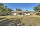 Spacious backyard with large grassy area and a covered patio at 6256 Kimball Ct, Spring Hill, FL 34606
