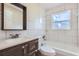 Clean bathroom with white tile and a tub shower combo at 6256 Kimball Ct, Spring Hill, FL 34606