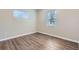 Well-lit bedroom with two windows and wood-look floors at 6256 Kimball Ct, Spring Hill, FL 34606