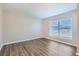 Spacious bedroom with large window and wood-look floors at 6256 Kimball Ct, Spring Hill, FL 34606