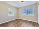 Bright bedroom with two windows and wood-look floors at 6256 Kimball Ct, Spring Hill, FL 34606