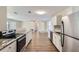 Modern kitchen with stainless steel appliances and granite countertops at 6256 Kimball Ct, Spring Hill, FL 34606
