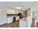 Modern kitchen with white cabinets, granite counters, and stainless steel appliances at 6256 Kimball Ct, Spring Hill, FL 34606