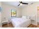 Bedroom with a king-size bed, nightstand, and window at 1344 Springdale St, Clearwater, FL 33755