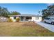 A renovated single story home with a covered porch and well maintained lawn at 1344 Springdale St, Clearwater, FL 33755