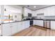 Modern kitchen featuring white shaker cabinets, granite countertops, and stainless steel appliances at 1344 Springdale St, Clearwater, FL 33755