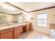 Bathroom with double vanity, granite countertop, and large mirror at 20102 Blue Daze Ave, Tampa, FL 33647