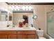 Double vanity bathroom with granite countertop and large mirror at 20102 Blue Daze Ave, Tampa, FL 33647