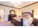 Elegant bedroom with a large bed, dresser, and access to another room at 20102 Blue Daze Ave, Tampa, FL 33647