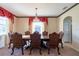 Bright dining room with large windows and a formal table setting at 20102 Blue Daze Ave, Tampa, FL 33647