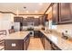 Spacious kitchen with granite countertops, stainless steel appliances, and dark wood cabinets at 20102 Blue Daze Ave, Tampa, FL 33647
