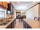 Kitchen features granite countertops, dark wood cabinets, and an island with seating at 20102 Blue Daze Ave, Tampa, FL 33647