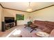 Living room with sectional sofa, large TV, and a view of the backyard at 20102 Blue Daze Ave, Tampa, FL 33647
