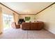 Relaxing living room featuring a large sectional sofa and access to backyard patio at 20102 Blue Daze Ave, Tampa, FL 33647