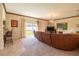 Spacious living room with sectional sofa, large TV, and view of backyard at 20102 Blue Daze Ave, Tampa, FL 33647