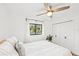 Bright bedroom with a queen bed, window, and white built-in closet at 4907 Erie Rd, Parrish, FL 34219