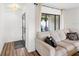 Light and airy living room with neutral colored couch and wood floors at 4907 Erie Rd, Parrish, FL 34219