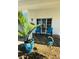 Relaxing front porch with blue chairs and potted plants at 9743 36Th N Way # 4, Pinellas Park, FL 33782