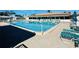 Community pool with lounge chairs and patio area at 9743 36Th N Way # 4, Pinellas Park, FL 33782