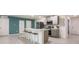 Modern kitchen with island, stainless steel appliances, and gray cabinets at 17412 Wellsley Ave, Port Charlotte, FL 33954
