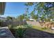 Landscaped backyard with a sitting area and wooden fence at 1278 Olympia Rd, Venice, FL 34293