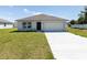 One-story house with attached garage and a well-maintained lawn at 22162 Seaton Ave, Port Charlotte, FL 33954